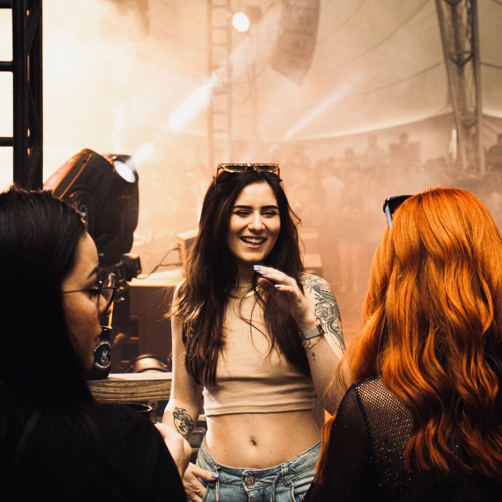 Friends laughing under the lights at a concert