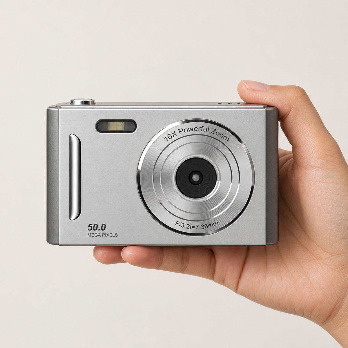 The Sundae Digicam in silver, held in a hand