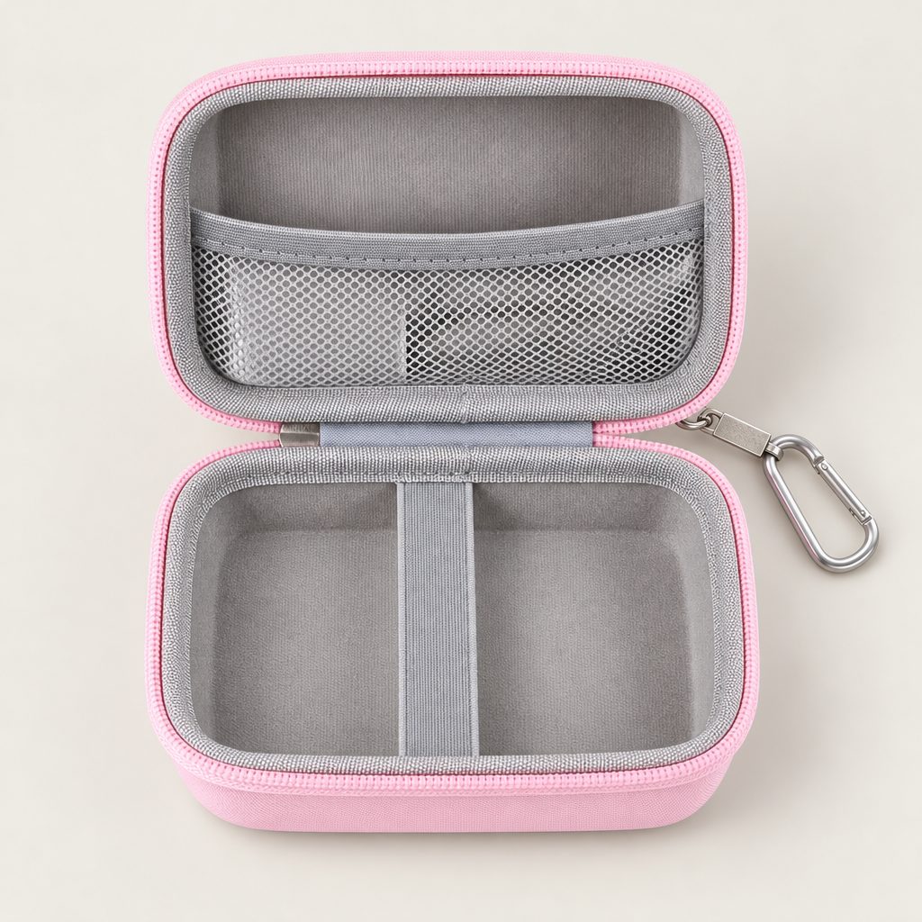 Pink hard case open flat: the mesh pocket in the lid and the elastic band in the base